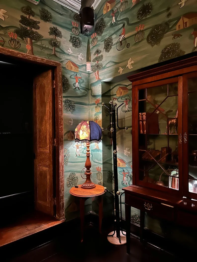 Room corner — bookcase and mural — Athletic Club & Social, Gardens, Cape Town