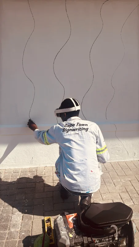 Cape Town Mural Arts team hand-painting a mural on site