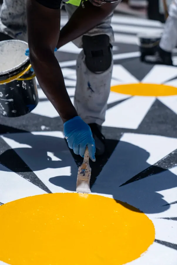 Hand-painting an exterior façade mural on site, Cape Town