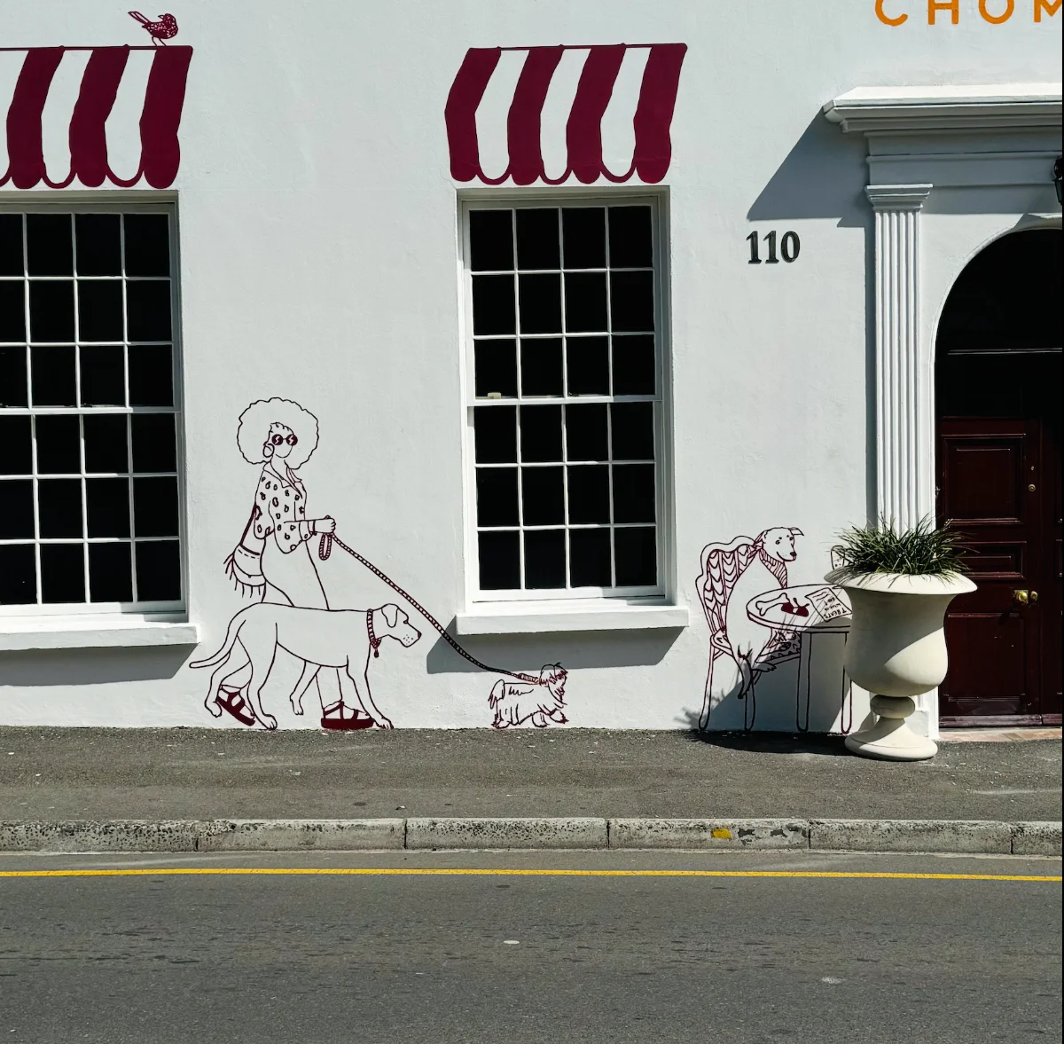 Dog walker detail — woman, labrador and terrier — House of Chommies, 110 Hatfield Street, Gardens, Cape Town